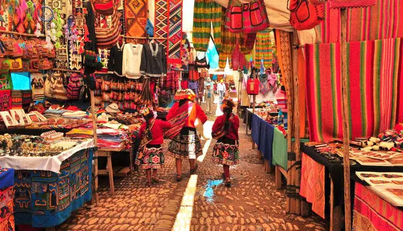 Andean woman weaving a traditional textile on a loom